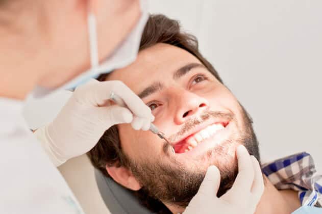Visible signs of gum recession around teeth