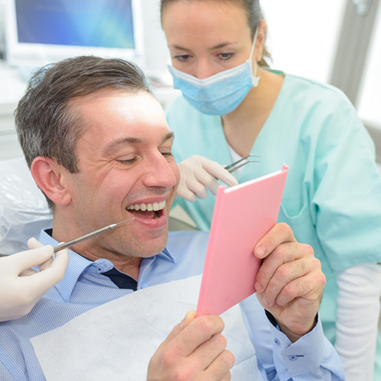 Dentist examining patient during dental implant treatment