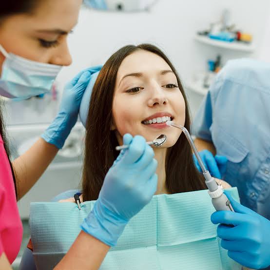 Dental veneers in Brampton consultation with a patient having her smile examined
