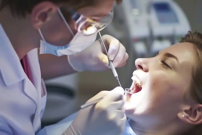 Dental professional working on a patient’s teeth