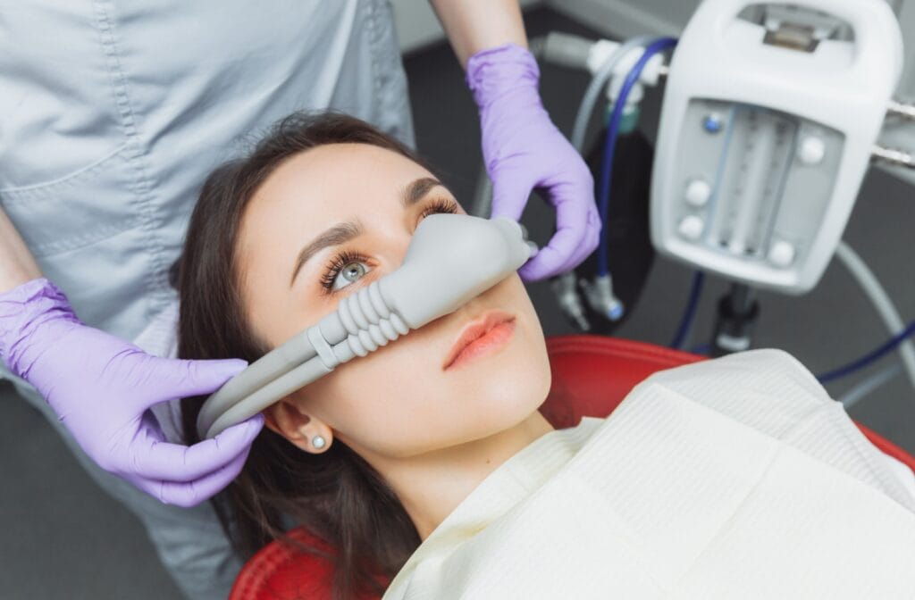 Dental sedation in Brampton illustrated by a patient wearing a nasal mask during a dental visit